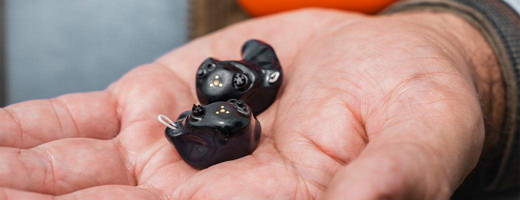 Image of hand holding SoundGear Phantom hearing protection devices